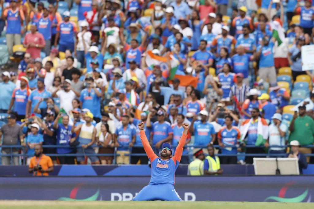 Rohit raises his arms to the heavens as India seal the deal